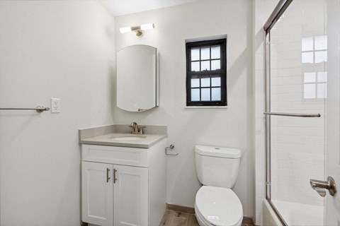 a bathroom with a toilet and a sink and a shower