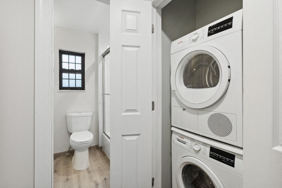 the laundry room has a washer and dryer and a toilet