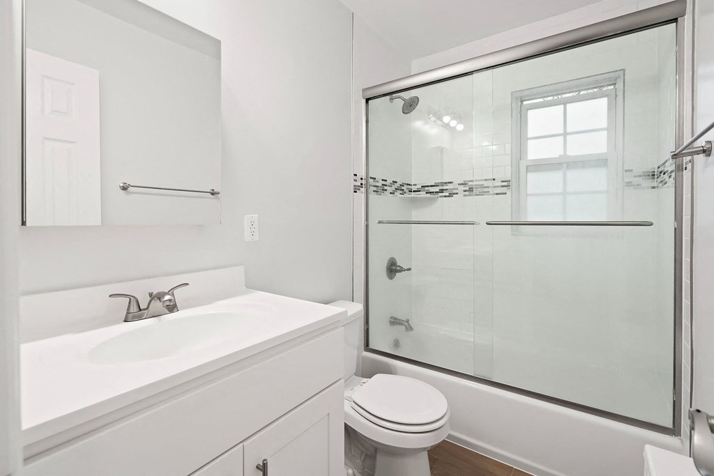 a bathroom with a sink toilet and a shower