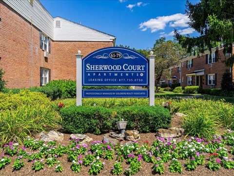 a sign in front of a brick building