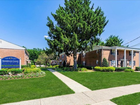 a sidewalk in front of a brick building