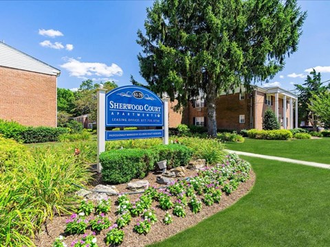 our sign in front of our building in the garden