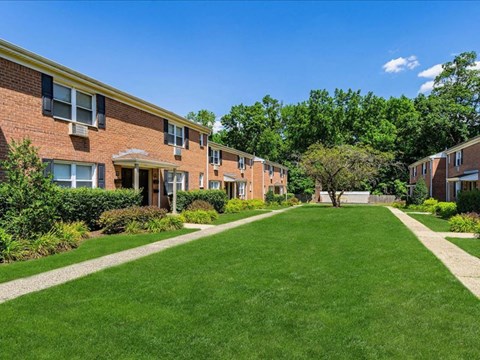 a green lawn in front of a brick building