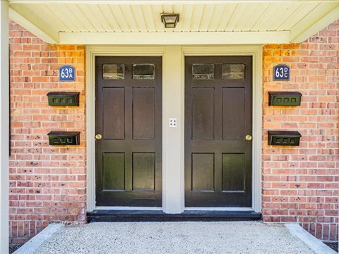 two doors on the side of a brick building