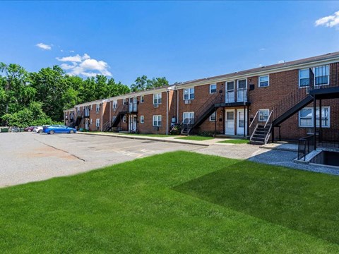 our apartments have a spacious parking lot and green grass