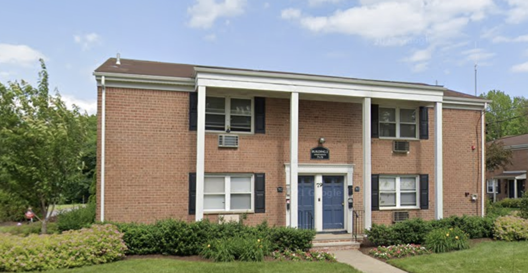 the front of a brick building with a blue door