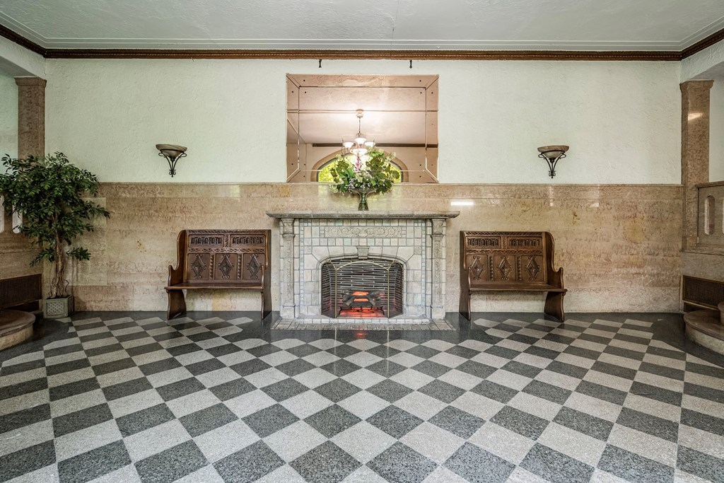 the lobby with a fireplace and checkered floor
