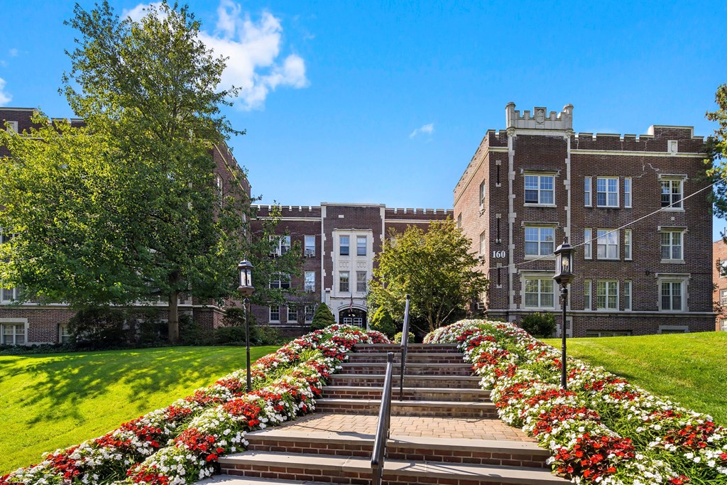 a row of stairs in front of a building with flowers