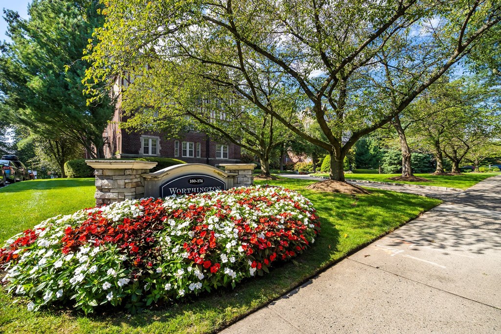 a garden of flowers in front of a building