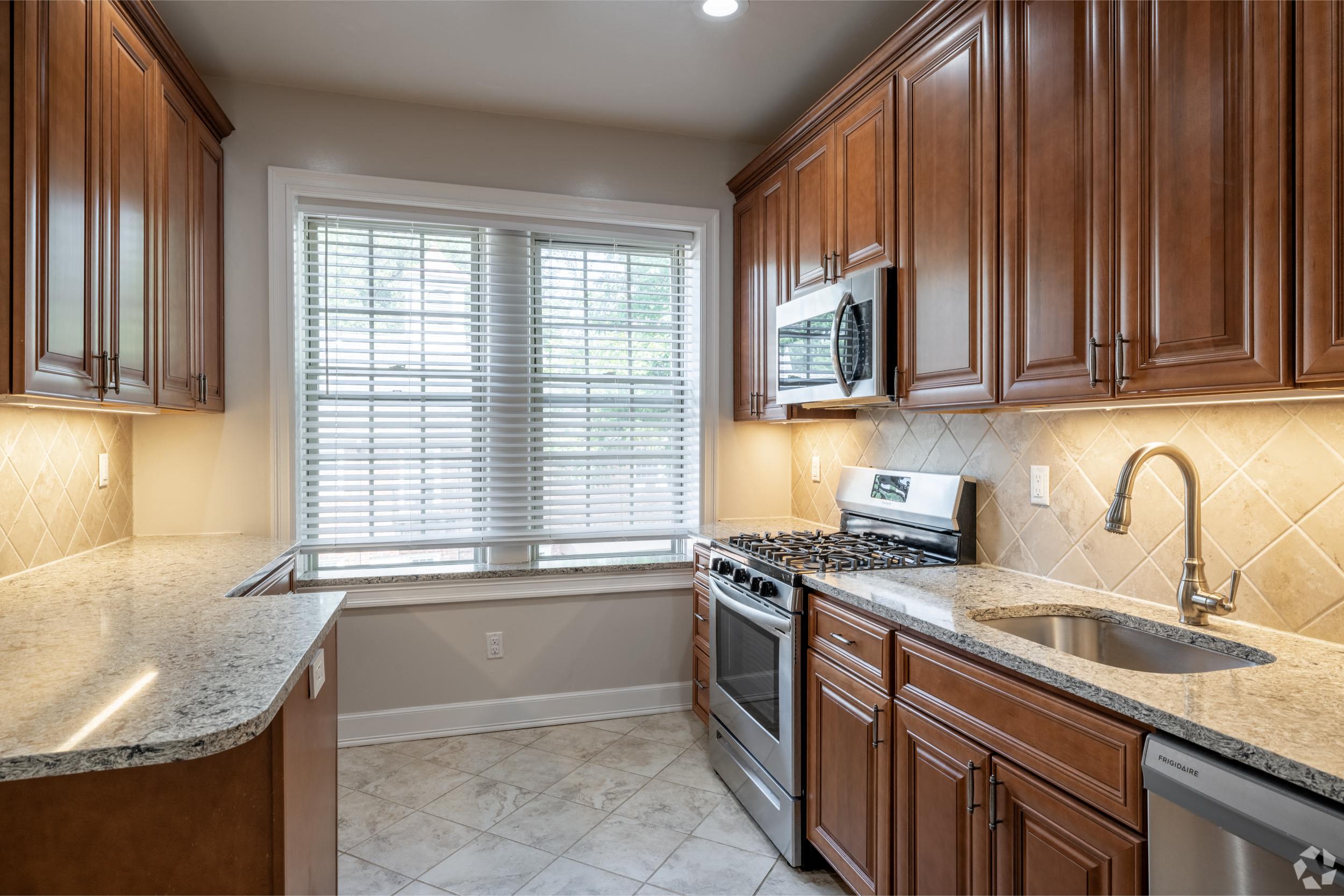 a kitchen with a sink and a stove and a window