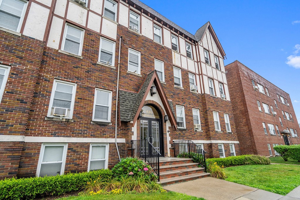 a red brick building with stairs in front of it