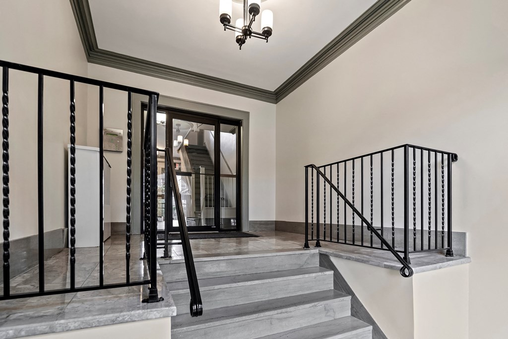 a view of the entryway of a house with stairs and a glass door