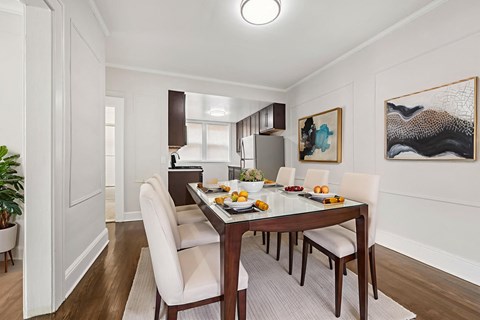 A dining room with a table set for a meal.