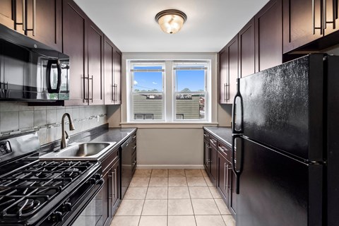 a kitchen with stainless steel appliances and a window