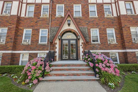 A red brick building with a black door and windows.