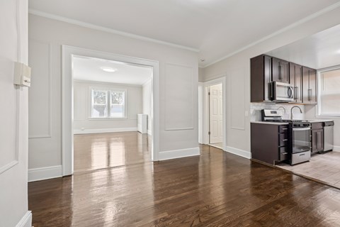 A kitchen with dark wood cabinets and appliances.