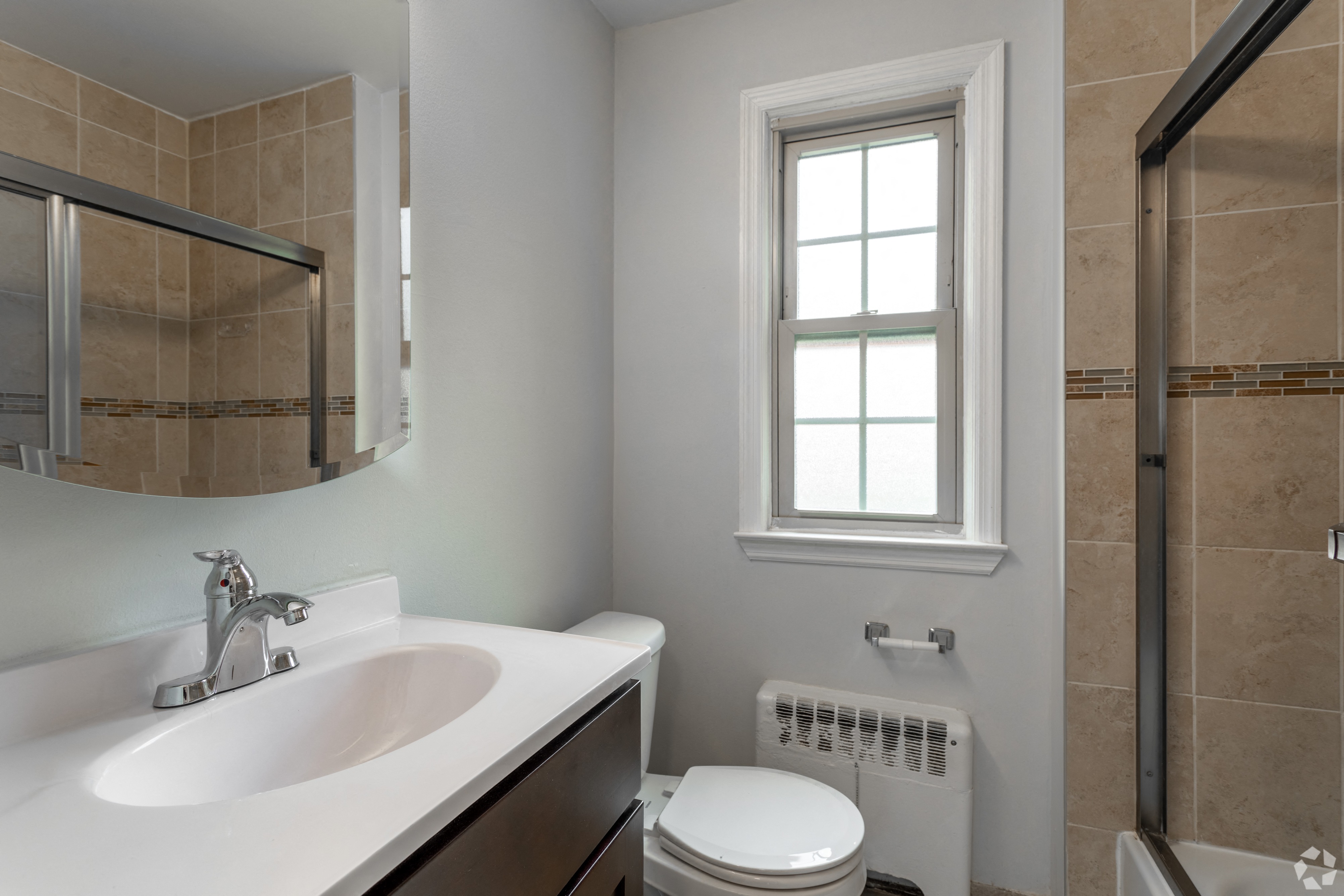a bathroom with a sink and a toilet and a shower