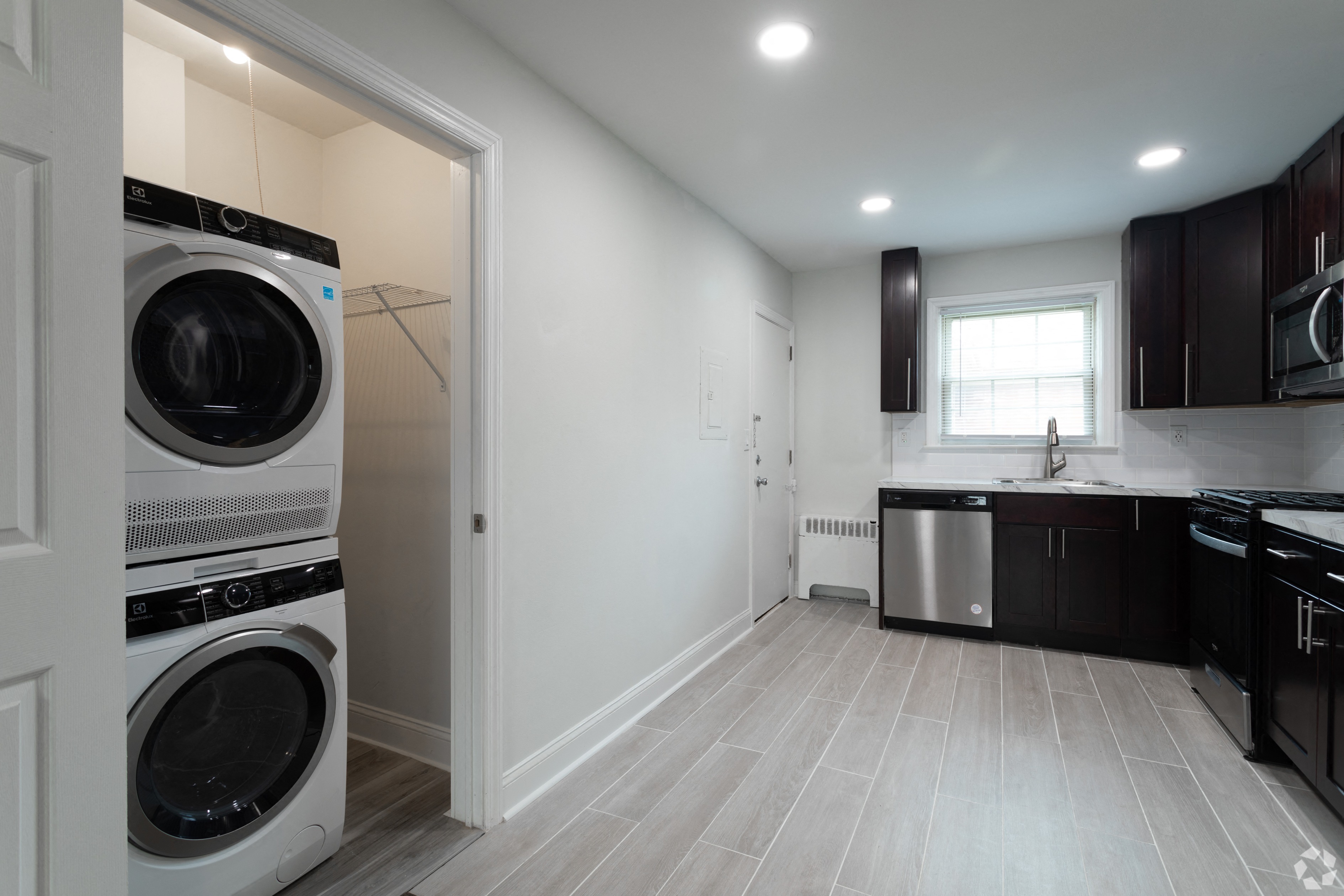 a laundry room with a washer and dryer and a kitchen with a sink