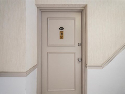 a white door with a gold door tag on it