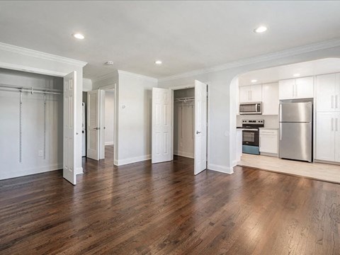 an empty kitchen with a stainless steel refrigerator and