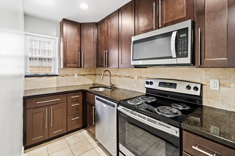 full kitchen with stainless steel appliances and granite counter tops and
