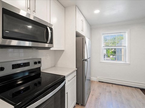 a kitchen with stainless steel appliances and a window