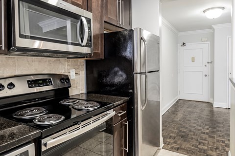 a kitchen with stainless steel appliances and a refrigerator