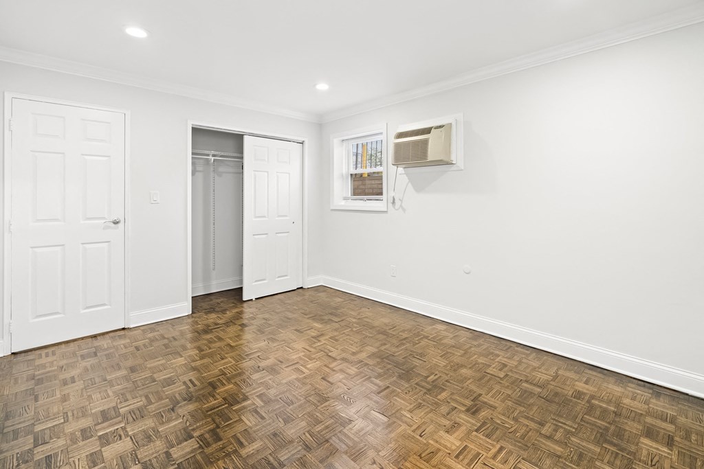 an empty living room with white walls and wood flooring