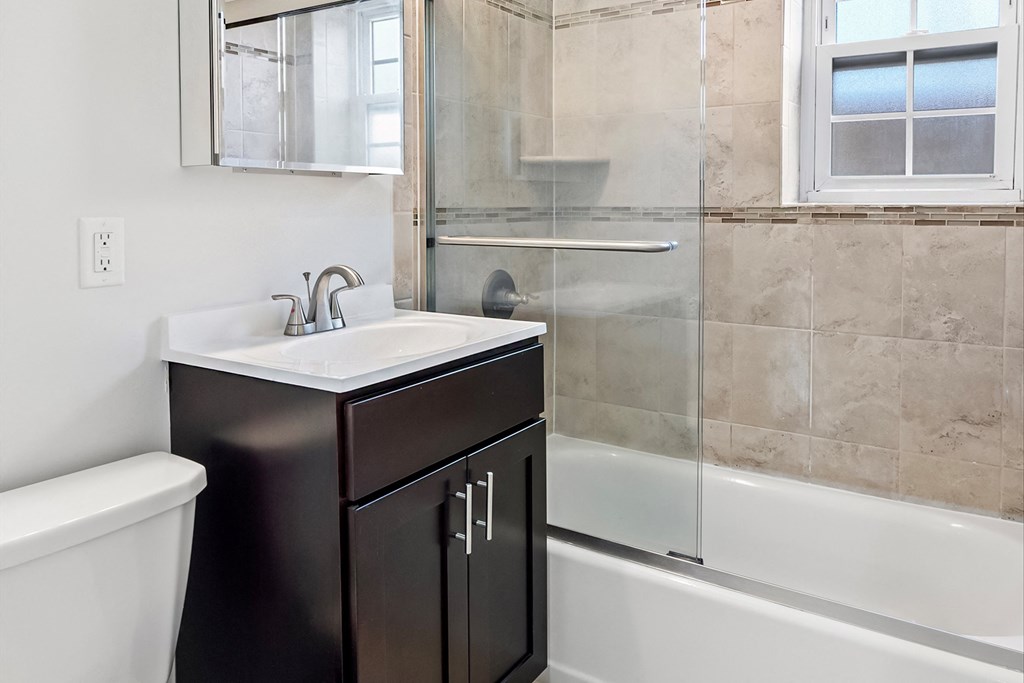 an image of a bathroom with a sink and a shower