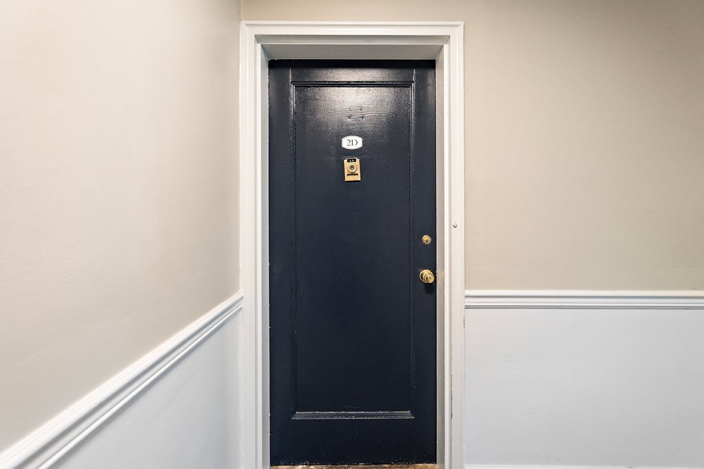 a black door with a white wall next to it