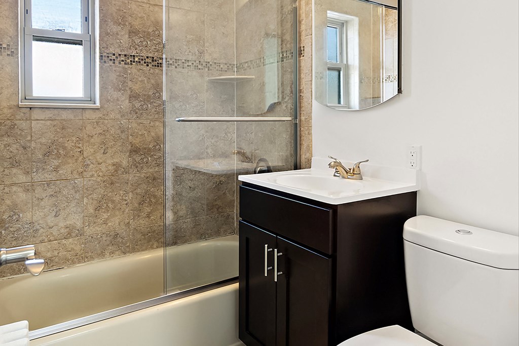 a bathroom with a sink toilet and shower