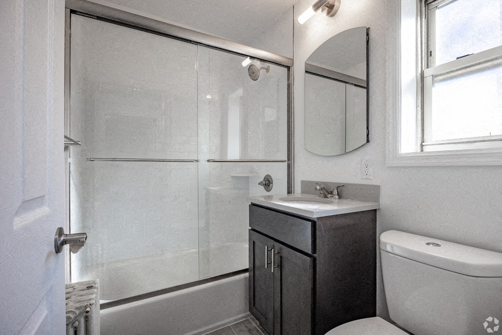 a bathroom with a shower and a sink and a toilet