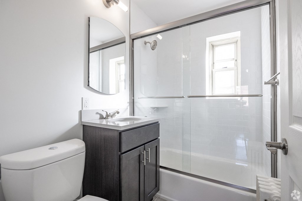 an image of a bathroom with a toilet sink and shower