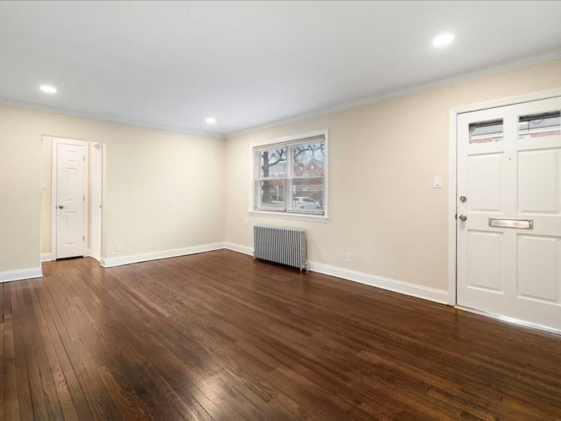A room with wooden floors and white walls.