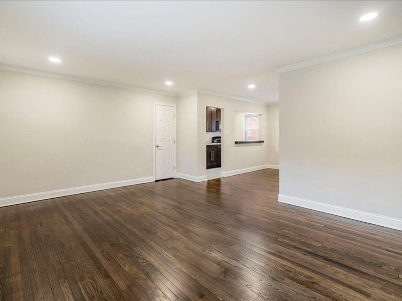 A room with wooden floors and white walls.