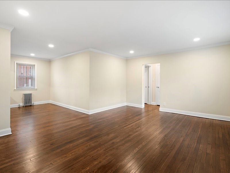 A room with wooden floors and white walls.