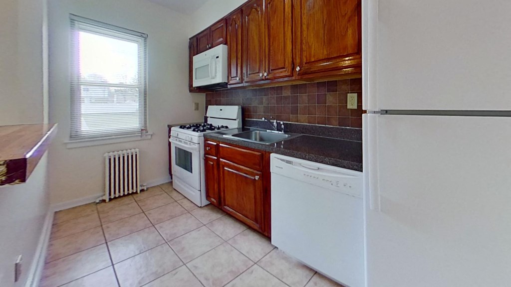 a kitchen with a stove refrigerator and sink