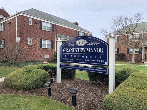 a sign in front of an apartment building