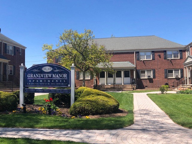 a sign in front of a brick building
