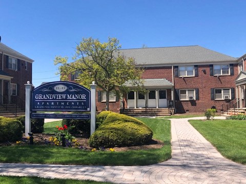 a sign in front of a brick building