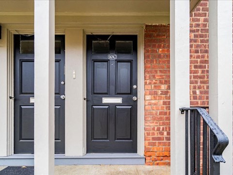 A black door with a number 100 on it.