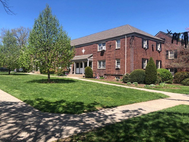 a brick building with a tree in front of it
