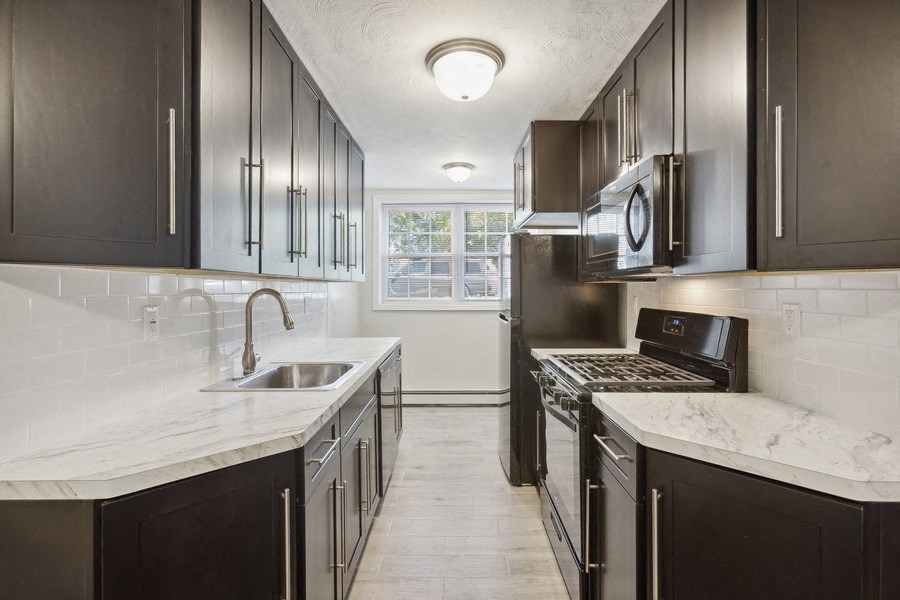 a kitchen with stainless steel appliances and marble counter tops