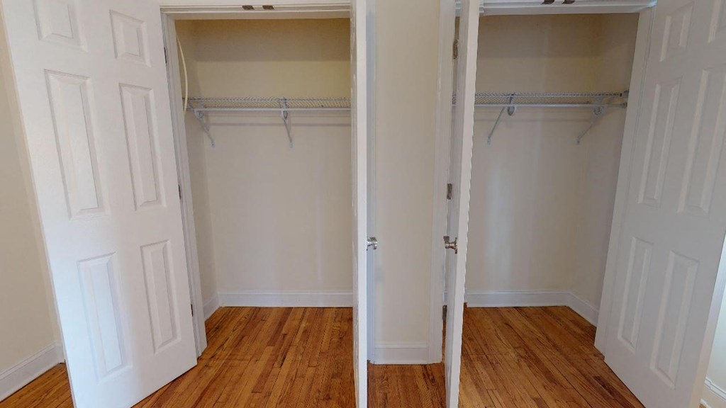 a room with two closets and a wooden floor