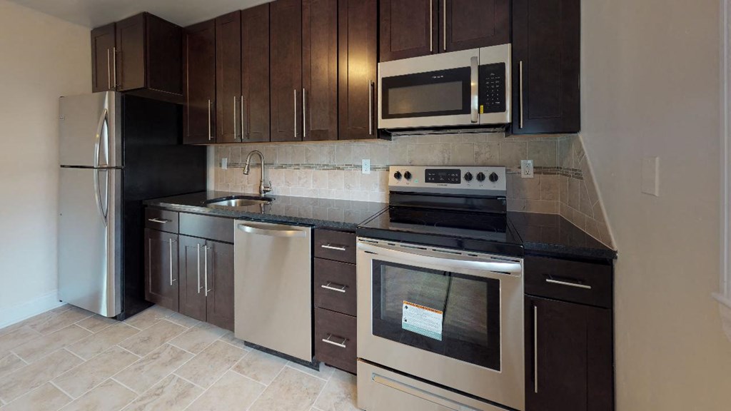 a kitchen with stainless steel appliances and wooden cabinets