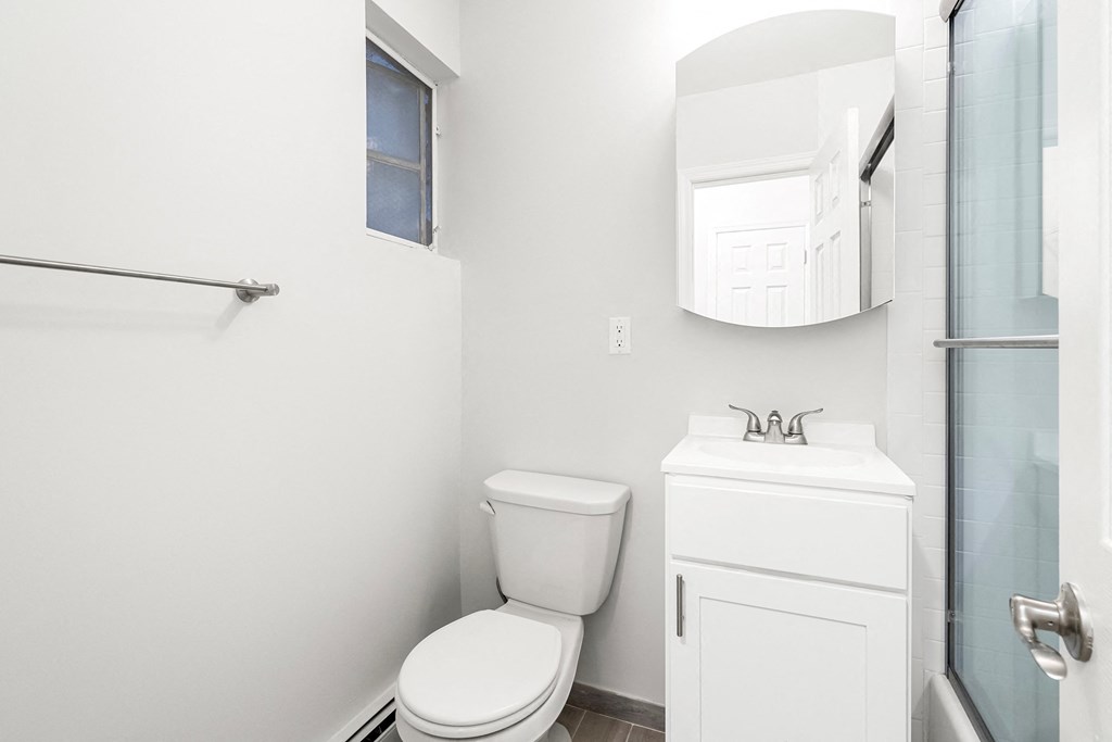 a bathroom with a toilet and a sink and a shower