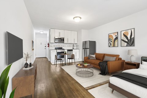 A modern living room with a brown sofa and a television on the wall.