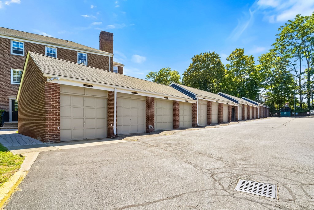 a row of garages in front of a brick building
