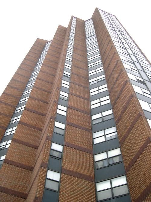 a tall red brick building with many windows