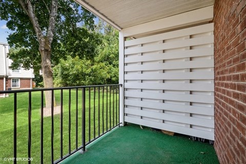 the backyard of a house with a fence and a tree